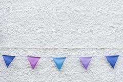 Colorful Party flags bunting hanging on white wall background. Minimal hipster style design. royalty free stock photography Colorful Party flags bunting hanging on white wall background. Minimal hipster style design. royalty free stock photography