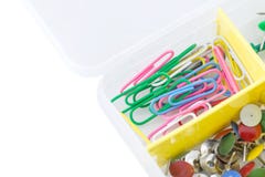 Colorful plastic coated paper clips in clear container. Isolated on white background Stock Images Colorful plastic coated paper clips in clear container. Isolated on white background Stock Images