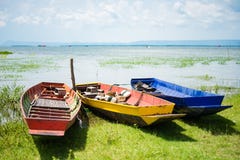 Colorful small fishing boats with anchor stones to stabilize and Stock Images Colorful small fishing boats with anchor stones to stabilize and Stock Images