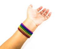 Colorful spheres magnet bracelet in a rainbow line in a woman ha Stock Photography Colorful spheres magnet bracelet in a rainbow line in a woman ha Stock Photography