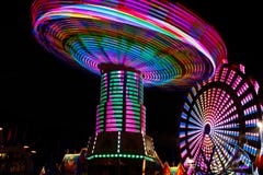 Colorful Spinning Swings, Ferris Wheel At Night Royalty Free Stock Image