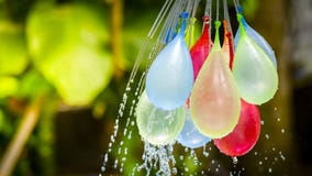 Colorful water balloons play in plastic swimming pool stock photography Colorful water balloons play in plastic swimming pool stock photography
