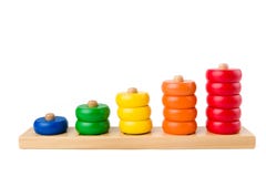 Colorful wooden children toy scores from one to five figures of the colored rings isolated on a white background. Studio shot. stock photo Colorful wooden children toy scores from one to five figures of the colored rings isolated on a white background. Studio shot. stock photo