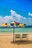 Colourful beach umbrella and two empty beach chairs royalty free stock photography Colourful beach umbrella and two empty beach chairs royalty free stock photography