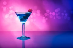 Colourful cocktails garnished with berries, background with light effects royalty free stock image Colourful cocktails garnished with berries, background with light effects royalty free stock image