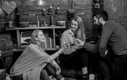Company of friends celebrate with mulled wine in cozy atmosphere, wooden background. Man and ladies on cheerful faces stock image Company of friends celebrate with mulled wine in cozy atmosphere, wooden background. Man and ladies on cheerful faces stock image