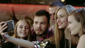 Company of young people is taking selfie in the bar stock footage Company of young people is taking selfie in the bar stock footage