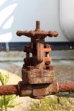 Completely rusted metal pipe connection with strong fully closed valve at abandoned industrial complex stock photo Completely rusted metal pipe connection with strong fully closed valve at abandoned industrial complex stock photo