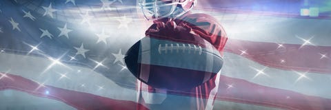 Composite image of american football player standing in rugby helmet and holding rugby ball stock photography Composite image of american football player standing in rugby helmet and holding rugby ball stock photography