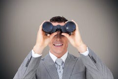 Composite image of businessman holding binoculars stock photo Composite image of businessman holding binoculars stock photo