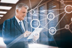 Composite image of businessman using his tablet stock image Composite image of businessman using his tablet stock image