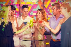 Composite image of group of friends toasting glass of cocktail in bar stock photography Composite image of group of friends toasting glass of cocktail in bar stock photography