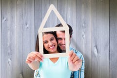 Composite image of happy young couple with house shape royalty free stock image Composite image of happy young couple with house shape royalty free stock image