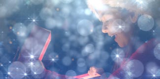 Composite image of little girl opening a magical christmas gift stock photos Composite image of little girl opening a magical christmas gift stock photos