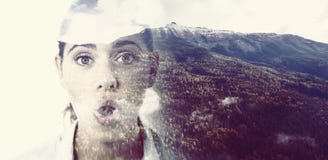 Composite image of mountain slope covered with green forest during winter. Mountain slope covered with green forest during winter against surprised female Stock Photo Composite image of mountain slope covered with green forest during winter. Mountain slope covered with green forest during winter against surprised female Stock Photo