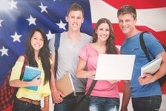 Composite Image Of A Smiling Group Of Students Holding A Laptop While Looking At The Camera Stock Images Composite Image Of A Smiling Group Of Students Holding A Laptop While Looking At The Camera Stock Images
