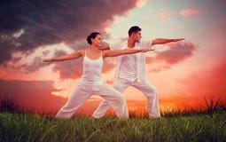 Composite image of peaceful couple in white doing yoga together in warrior position royalty free stock photos Composite image of peaceful couple in white doing yoga together in warrior position royalty free stock photos