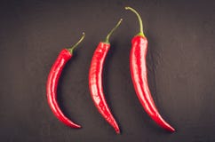 composition de peppe de piment sur une pierre foncée/poivre d'un rouge ardent du Chili sur un fond en pierre foncé Vue sup?rieure photographie stock composition de peppe de piment sur une pierre foncée/poivre d'un rouge ardent du Chili sur un fond en pierre foncé Vue sup?rieure photographie stock