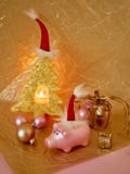 Composition Of A Toy Pink Pig In A Santa Hat, Balls, Decorative Christmas Tree Gingerbread, A Burning Candle On Golden Wrapping Pa Royalty Free Stock Photography