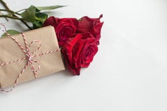 Composition Of Gift And Bouquet Of Red Roses On White Background . Happy Valentines Day. Top View. Space For Text Stock Photo