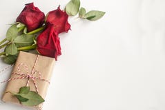 Composition With Gift And Bouquet Of Red Roses On White Background . Happy Valentines Day. Top View. Space For Text Stock Image