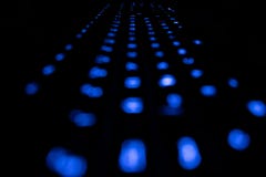 Computer keybord with bokeh blue lights in the dark stock images Computer keybord with bokeh blue lights in the dark stock images