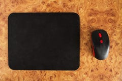 Computer mat and computer mouse on a brown patterned background, close-up, optical stock images Computer mat and computer mouse on a brown patterned background, close-up, optical stock images