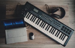 Computer music, home studio equipment. midi keyboard, laptop computer, headphone and loudspeaker monitor stock photos Computer music, home studio equipment. midi keyboard, laptop computer, headphone and loudspeaker monitor stock photos