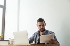 Concentrated bearded designer with pantone color swatch palette stock photo Concentrated bearded designer with pantone color swatch palette stock photo