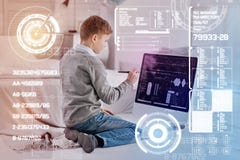 Concentrated child using a modern stylus while doing homework Royalty Free Stock Image Concentrated child using a modern stylus while doing homework Royalty Free Stock Image