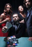 Concentrated men and women playing poker in casino stock photos Concentrated men and women playing poker in casino stock photos