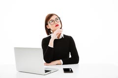 Concentrated thinking young business lady using laptop royalty free stock photography Concentrated thinking young business lady using laptop royalty free stock photography
