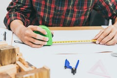 Concept architects,engineer equipment measurement. On the desk with a blueprint in the office. Vintage, Sunset light.Selective Focus royalty free stock photo Concept architects,engineer equipment measurement. On the desk with a blueprint in the office. Vintage, Sunset light.Selective Focus royalty free stock photo