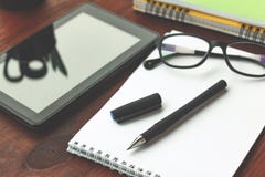 The concept: the beginning of work or project. tablet computer and glasses, Pen, open notebook on office desk. Royalty Free Stock Photos The concept: the beginning of work or project. tablet computer and glasses, Pen, open notebook on office desk. Royalty Free Stock Photos