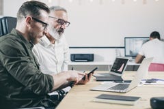 Concept of business people brainstorming.Bearded man pointinh hand on screen of mobile phone. Royalty Free Stock Photo Concept of business people brainstorming.Bearded man pointinh hand on screen of mobile phone. Royalty Free Stock Photo
