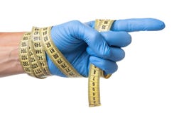 Concept de surpoids, perte de poids, liposuccion Le docteur dans le gant bleu et la bande de mesure dans des ses mains est sur le photographie stock Concept de surpoids, perte de poids, liposuccion Le docteur dans le gant bleu et la bande de mesure dans des ses mains est sur le photographie stock
