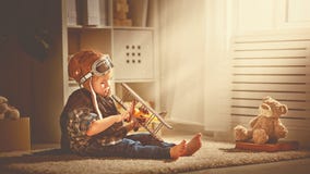 Concept of dreams and travels. pilot aviator child with a toy a Royalty Free Stock Photography Concept of dreams and travels. pilot aviator child with a toy a Royalty Free Stock Photography