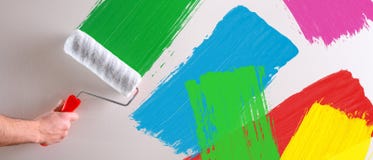 Concept of hand painting multicolored samples on wall stock photo Concept of hand painting multicolored samples on wall stock photo