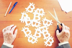 Man cuts out from paper many bitcoin signs Stock Images Man cuts out from paper many bitcoin signs Stock Images