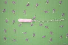 The concept of the menstrual cycle, menstruation and intimate products with an internal swab, on green background with copy space royalty free stock images The concept of the menstrual cycle, menstruation and intimate products with an internal swab, on green background with copy space royalty free stock images