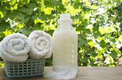 Concept Of Clean And Soft Washing. Plastic Bottle Of Softner Near The Clean Towels Royalty Free Stock Images Concept Of Clean And Soft Washing. Plastic Bottle Of Softner Near The Clean Towels Royalty Free Stock Images