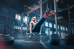 Concept: power, strength, healthy lifestyle, sport. Powerful attractive muscular woman at CrossFit gym royalty free stock photography Concept: power, strength, healthy lifestyle, sport. Powerful attractive muscular woman at CrossFit gym royalty free stock photography