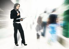 Concept of a successful businesswoman with suit, standing holding book and over exposed abstract background royalty free stock photo Concept of a successful businesswoman with suit, standing holding book and over exposed abstract background royalty free stock photo