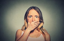 Concerned scared shocked woman covering her mouth stock photo Concerned scared shocked woman covering her mouth stock photo