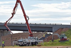 A concete pump finishes pouring a revetment stock photos A concete pump finishes pouring a revetment stock photos