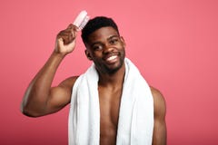 Concetto di tempo della doccia Macho con l'asciugamano bianco sul suo collo che spazzola i suoi capelli immagini stock libere da diritti Concetto di tempo della doccia Macho con l'asciugamano bianco sul suo collo che spazzola i suoi capelli immagini stock libere da diritti