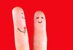 Concetto felice delle coppie - un uomo con il fiore e una donna, dipinta a fotografie stock Concetto felice delle coppie - un uomo con il fiore e una donna, dipinta a fotografie stock