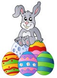 Conejito en la pila de huevos de Pascua stock de ilustración Conejito en la pila de huevos de Pascua stock de ilustración