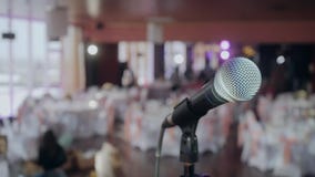 Microphone over the Abstract blurred conference hall or wedding banquet background
