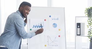 Confident African American Guy Presenting New Business Project In Office Royalty Free Stock Image